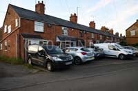 The five end cottages were used by Simon Collier c.1890 to c.1914 for shoe production in Kislingbury.